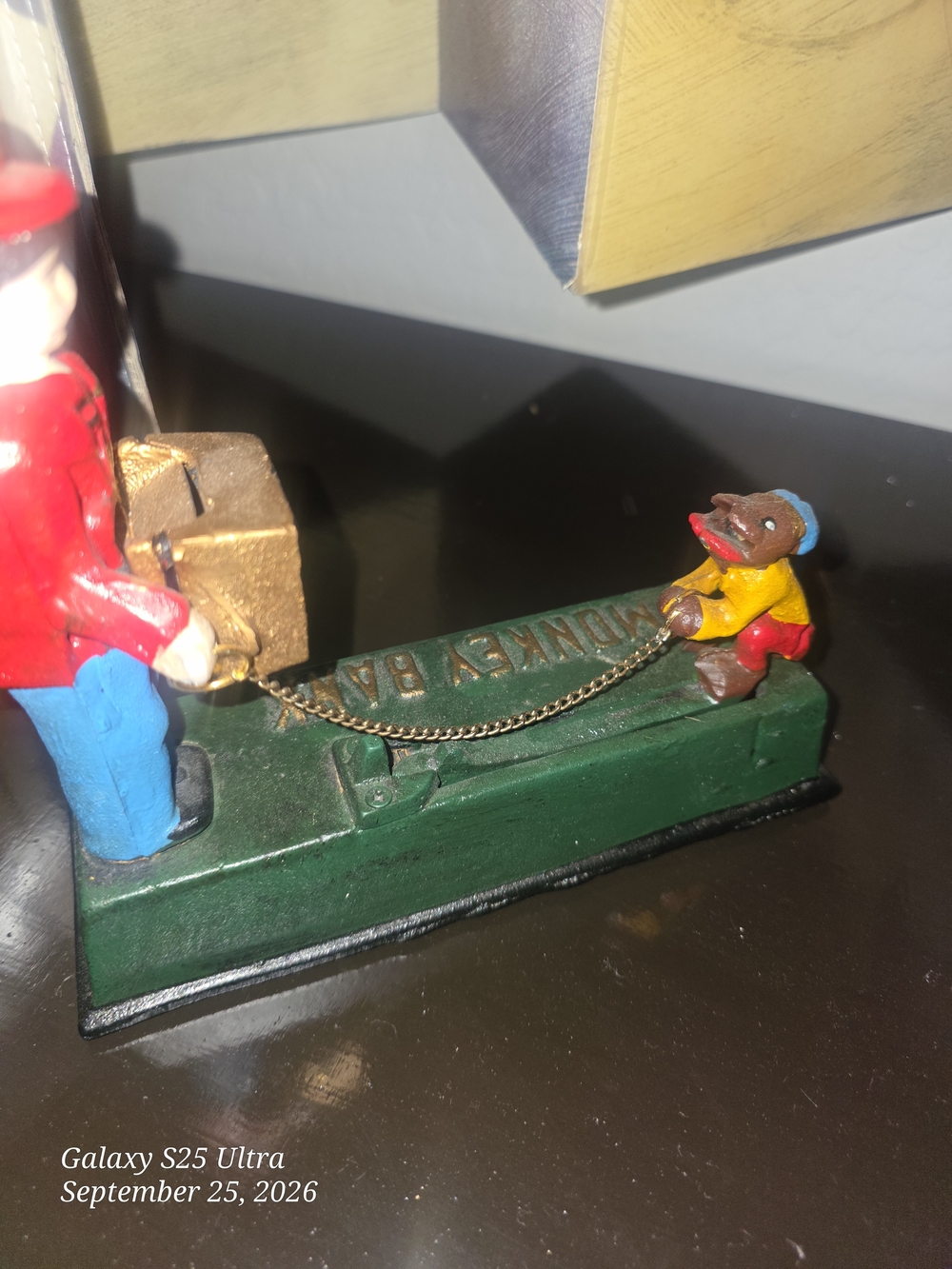 Vintage-Style Green Monkey Bank Toy with Red and Yellow Accents